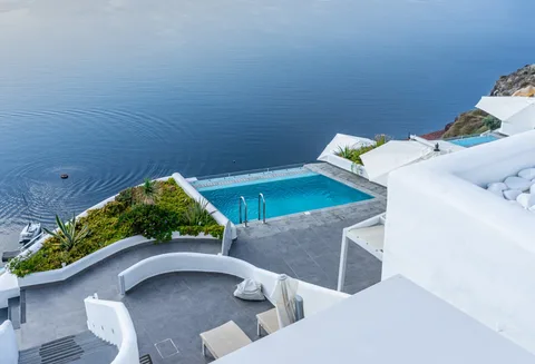 Santorini Cave Hotel & Resort | Safari Sutra Holidays Santorini caldera-view cave hotel with infinity pool — luxury Greece accommodation by Safari Sutra Holidays