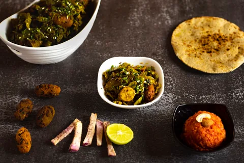 Gujarat Thali — Local Food on Tour | Safari Sutra Holidays Traditional Gujarat thali with dal dhokli, kadhi and bajra rotla — food on Gujarat tour | Safari Sutra