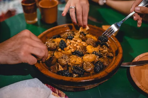 Moroccan Cuisine and Food Trail | Safari Sutra Holidays Traditional Moroccan lamb tagine with preserved lemon and olives — food in Morocco | Safari Sutra Holidays