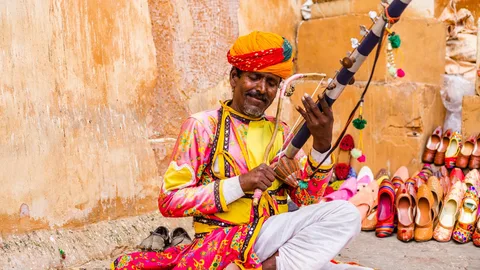Rajasthan Folk Culture & Music | Safari Sutra Holidays Manganiyar folk musician performing in Rajasthan desert — cultural tours | Safari Sutra
