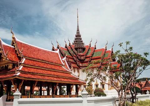 Buddhist Culture & Temples in Thailand | Safari Sutra Holidays Buddhist monks in saffron robes at a Thai temple at dawn — cultural Thailand tours | Safari Sutra Holidays