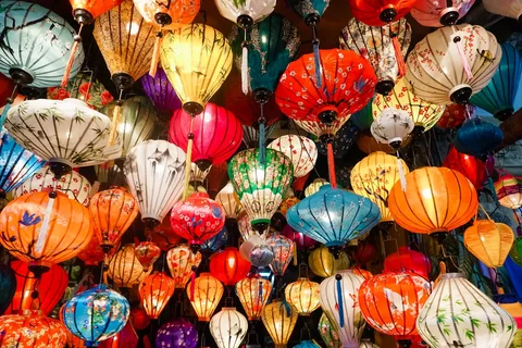 Hoi An Lantern Festival Vietnam | Safari Sutra Holidays Colourful paper lanterns floating on the Thu Bon River during Hoi An Full Moon Festival Vietnam