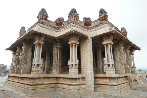 The intricately carved monolithic stone pillars of the Kalyana Mantapa at the Vijaya Vittala Temple complex in Hampi