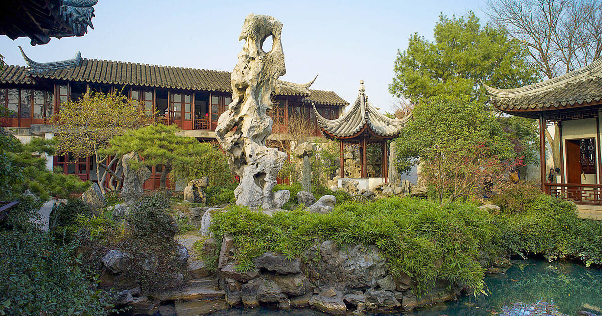 Suzhou classical garden pavilion reflected in still lotus pond — China luxury tour from India