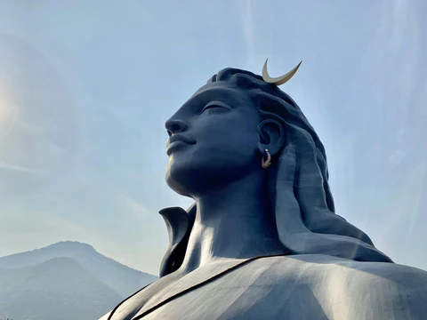 The Adiyogi Shiva Statue at the Isha Yoga Center, Coimbatore The massive black steel bust of Adiyogi Shiva, the world's largest bust sculpture, with the Velliangiri mountains in the background
