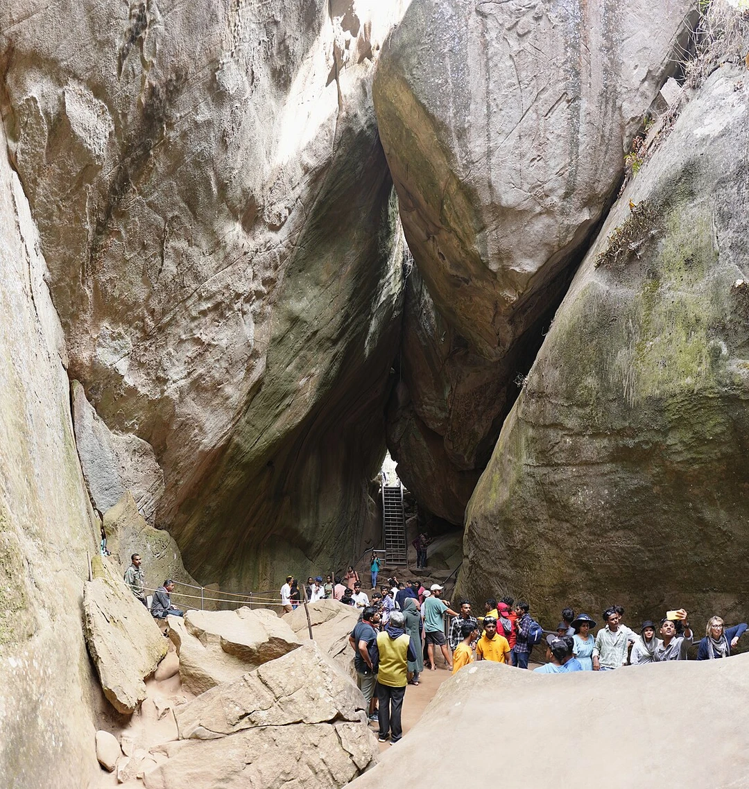 Tourists gather inside the Edakkal Caves in Kerala, a natural fissure between giant boulders famous for its prehistoric rock carvings