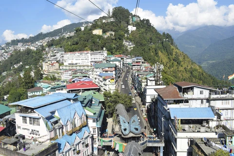 A view from the Gangtok Ropeway, looking down on the colorful cityscape as it spreads across the lush green Himalayan hills
