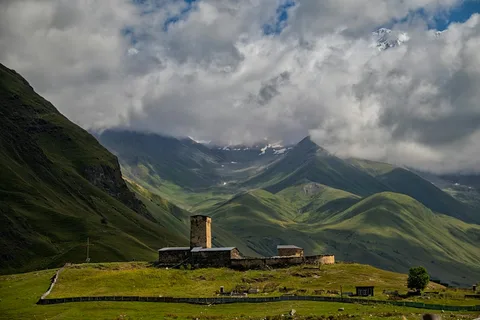 Towers in the Clouds: Svaneti & Kazbegi Adventure | Safari Sutra Holidays Stone towers of Ushguli below Shkhara's glaciers on a Georgia adventure tour package