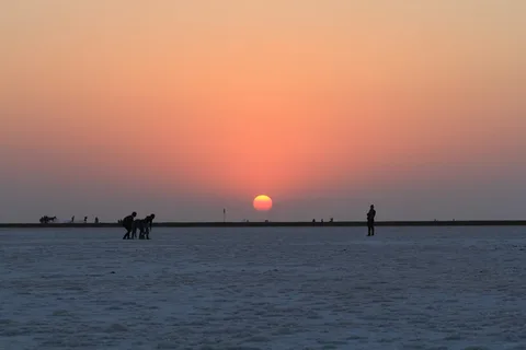 Gujarat Family Odyssey: Rann, Gir & the Sacred Coast | Safari Sutra Holidays Family standing on the white salt flats of Rann of Kutch at sunset — Gujarat family tour package from India