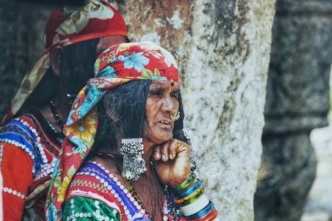 Gujarat Deep Culture: Craft Villages, Textiles, Stepwells & the Wild Ass Sanctuary | Safari Sutra Holidays Kutch woman in traditional costume demonstrating embroidery — Gujarat cultural immersion tour from India