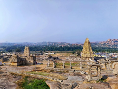 An elevated view of the Hampi ruins, showing the Virupaksha Temple set against the unique, boulder-strewn landscape of Karnataka