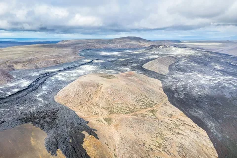 Above the Volcanoes: Iceland Luxury Escape | Safari Sutra Holidays Helicopter over Iceland's volcanic landscape on a luxury Iceland tour package from India