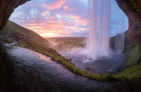 Waterfalls, Whales & Warm Lagoons: Iceland Family Holiday | Safari Sutra Holidays Family walking behind Seljalandsfoss waterfall in summer on an Iceland family tour package