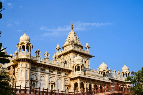 The Historic Albert Hall Museum in Jaipur The stunning facade of the Albert Hall Museum in Jaipur, showcasing its intricate domes and towers against a clear blue sky