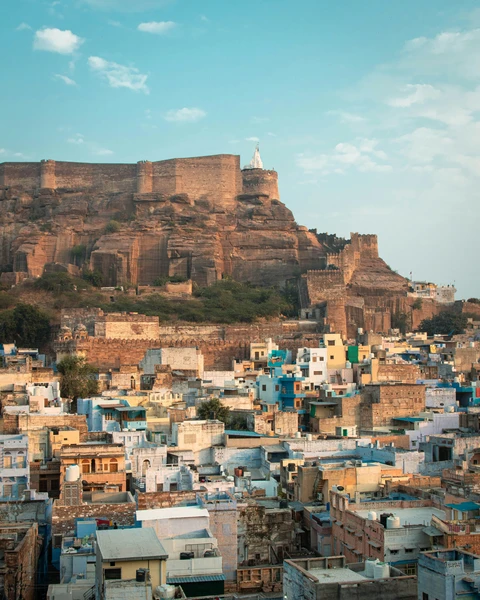 Mehrangarh Fort Overlooking Jodhpur, the Blue City The majestic Mehrangarh Fort sits on a rocky cliff, overlooking the dense cluster of blue houses of the old city of Jodhpur