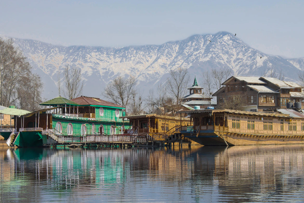 Shikara boats on misty Dal Lake at sunrise, Kashmir family holiday package from India