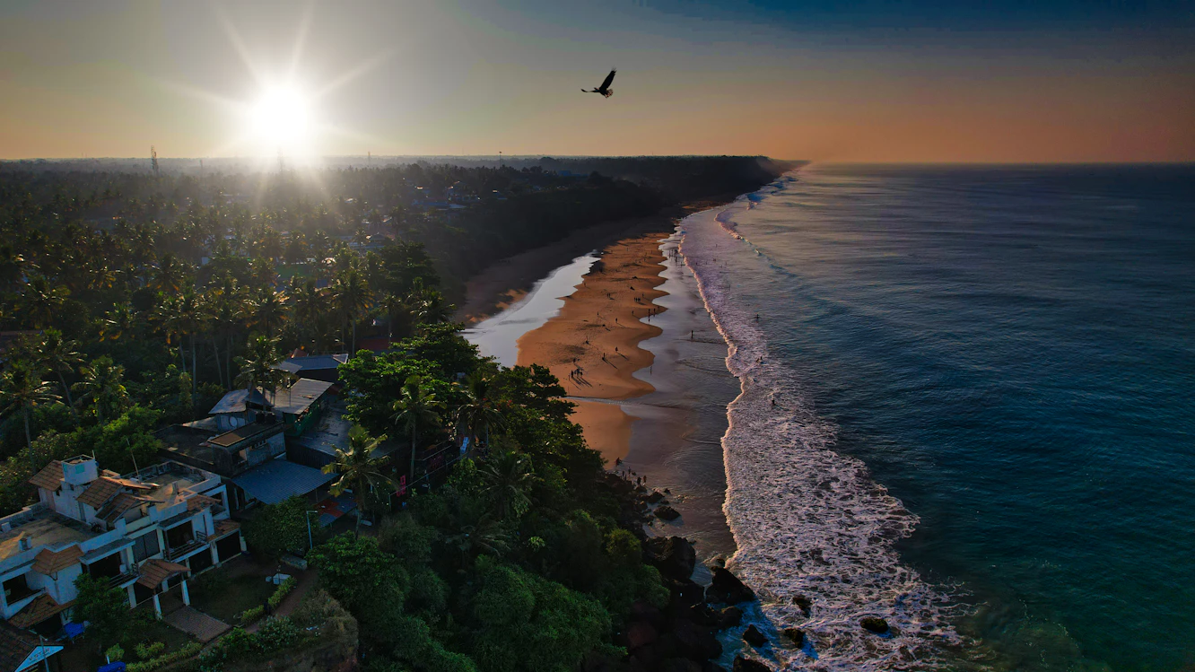 Varkala clifftop at sunset with the Arabian Sea below — Kerala honeymoon package from India
