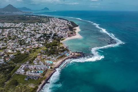 Mauritius Honeymoon Escape: 5 Nights of Lagoons, Sunsets & Slow Mornings | Safari Sutra Holidays Couple walking on Belle Mare beach on a Mauritius honeymoon package