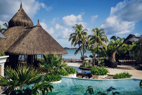 Mauritius Luxury Loop: 8 Nights Across Two Coastlines, Five-Star Throughout | Safari Sutra Holidays 5-star resort infinity pool over the lagoon on a Mauritius luxury holiday package