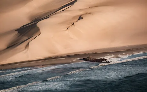 Namibia Photography Expedition | Safari Sutra Holidays Skeleton Coast shipwreck in Namibia fog at dawn — photography tour from India with Safari Sutra