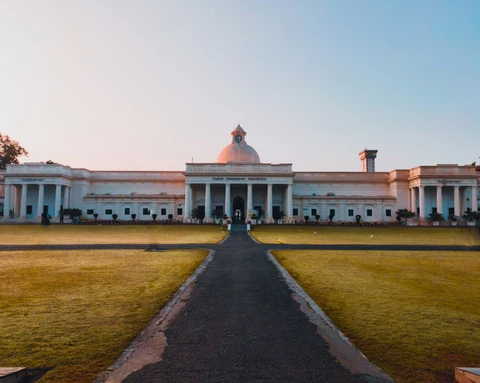 White domed museum building at golden hour White domed museum building with broad lawn in front at golden hour