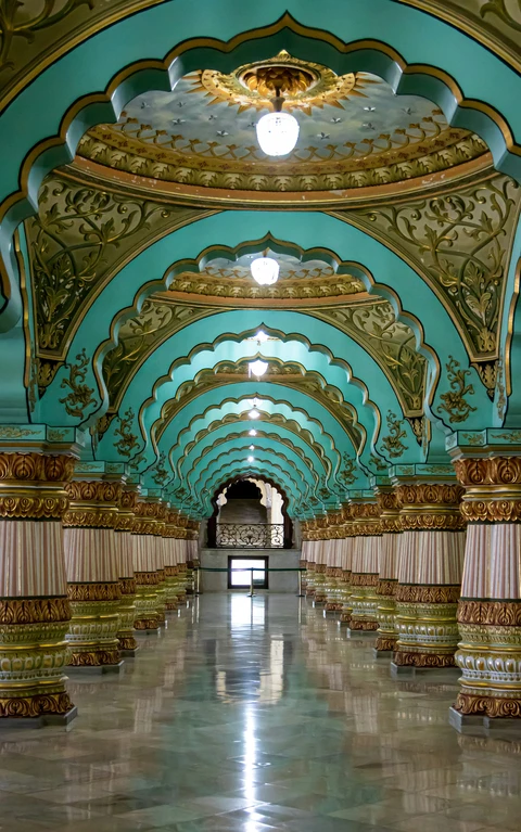 Grand Interior of the Mysore Palace, Mysuru The magnificent corridor of the Mysore Palace, featuring its famous ornate pillars and turquoise scalloped arches