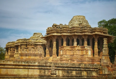 The Historic Modhera Sun Temple in Gujarat The intricately carved sandstone pillars and walls of the ancient Sun Temple in Modhera, a masterpiece of 11th-century architecture