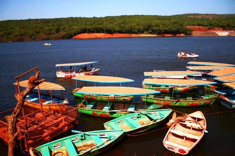 Boating on the Scenic Venna Lake in Mahabaleshwar Colorful rowboats and paddle boats on the calm waters of Venna Lake, a popular tourist attraction in the hill station of Mahabaleshwar