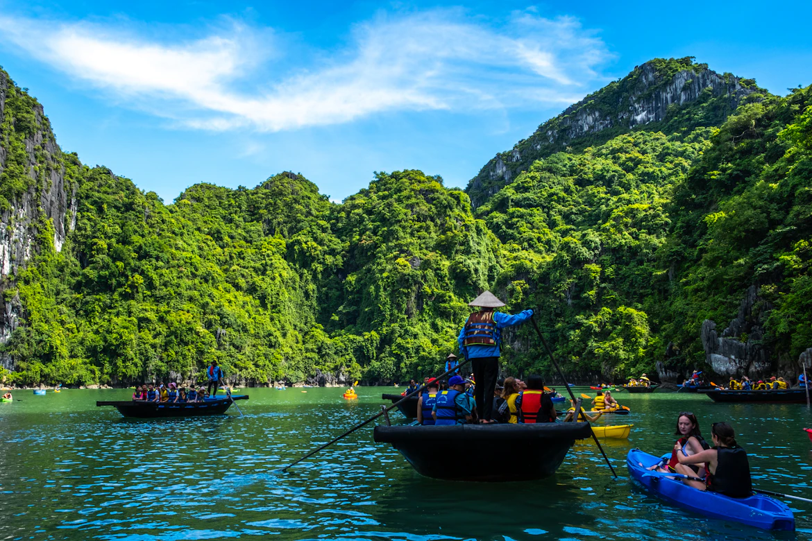Family kayaking through Ha Long Bay limestone karsts — Vietnam family holiday package from India