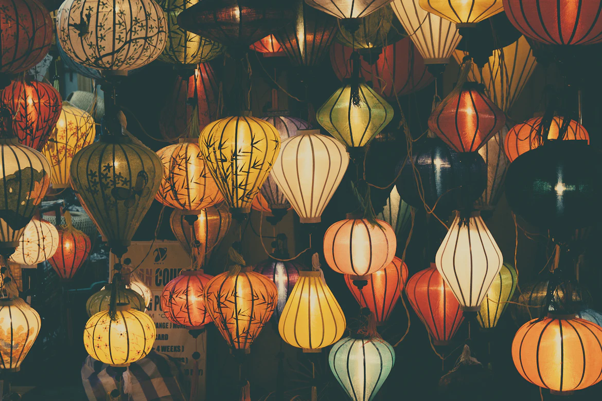 Hoi An Ancient Town glowing with yellow lanterns reflected in the Thu Bon River — Vietnam cultural tour from India
